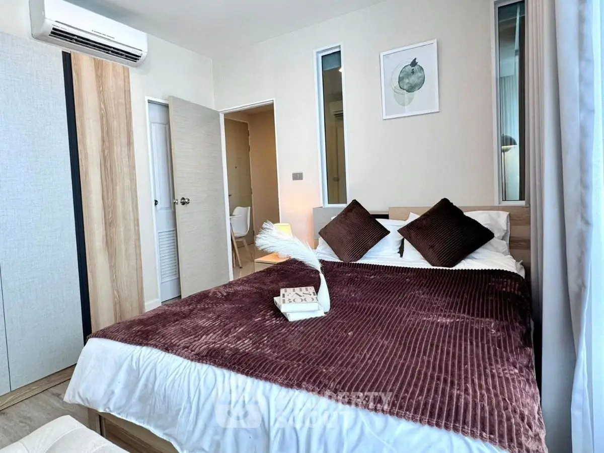 Cozy bedroom with modern decor and plush bedding in a stylish apartment.