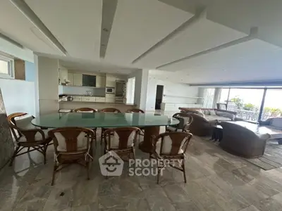 Spacious open-plan living and dining area with modern kitchen and large windows