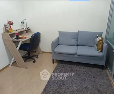 Cozy study room with modern desk and comfortable sofa, perfect for productivity and relaxation.
