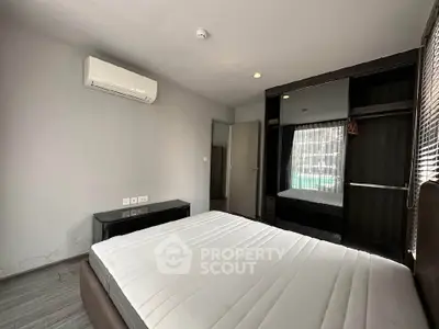 Modern bedroom with air conditioning and built-in wardrobe in a stylish apartment.