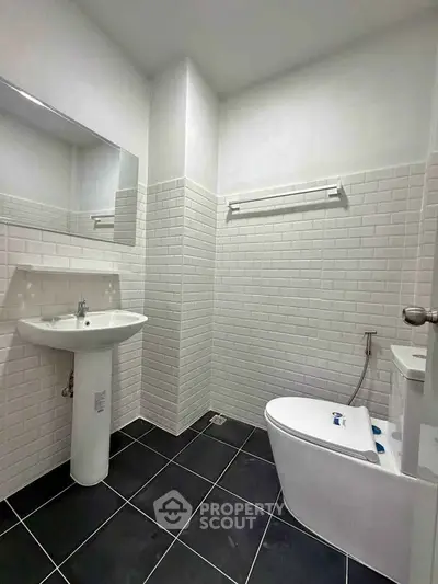 Modern bathroom with sleek white tiles and contemporary fixtures