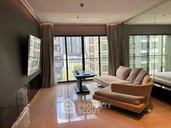 Modern living room with sleek sofa and large windows offering city view