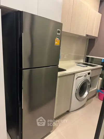 Modern kitchen with sleek appliances and washing machine