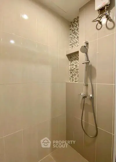 Modern bathroom shower with sleek tile design and built-in shelf
