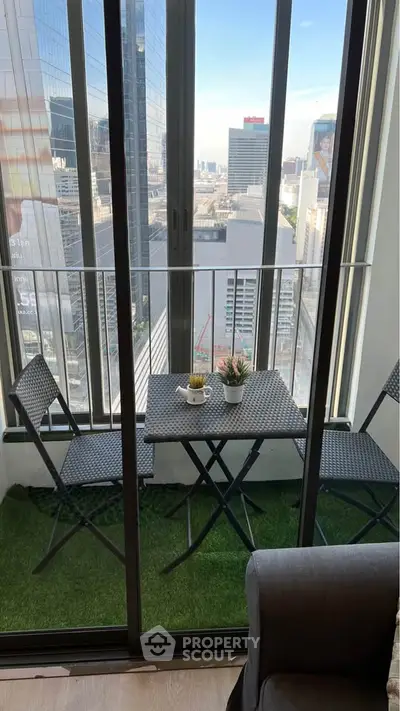 Chic urban balcony with city view, perfect for relaxation and enjoying the skyline.