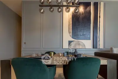 Elegant dining area with modern art and stylish lighting in a contemporary home.