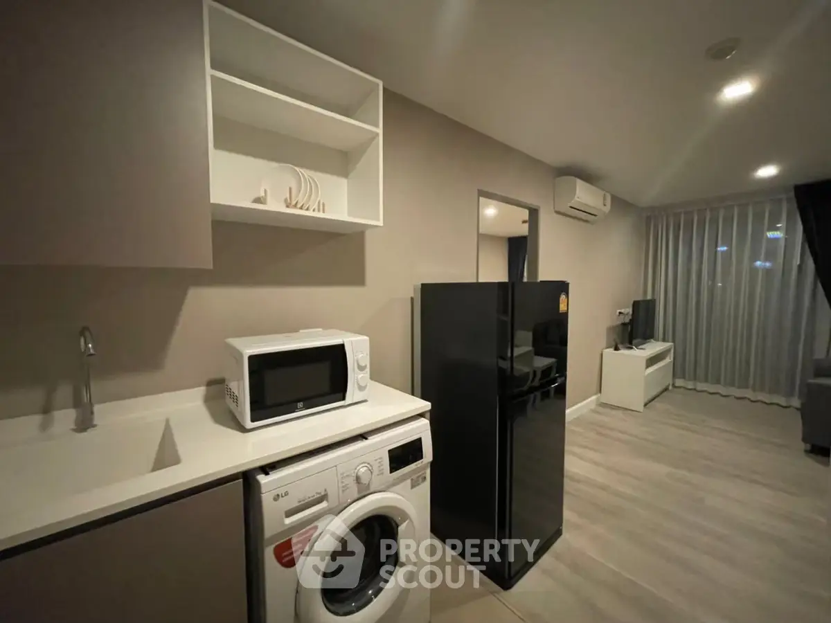 Modern apartment interior with kitchen appliances and cozy living area
