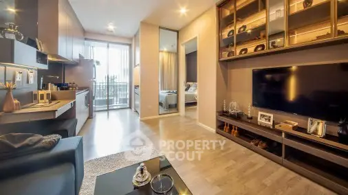 Modern living room with open kitchen and stylish decor in a cozy apartment.