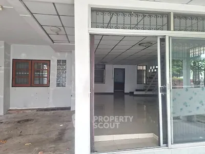 Spacious open-plan living area with sliding glass doors and tiled flooring, ideal for modern living.