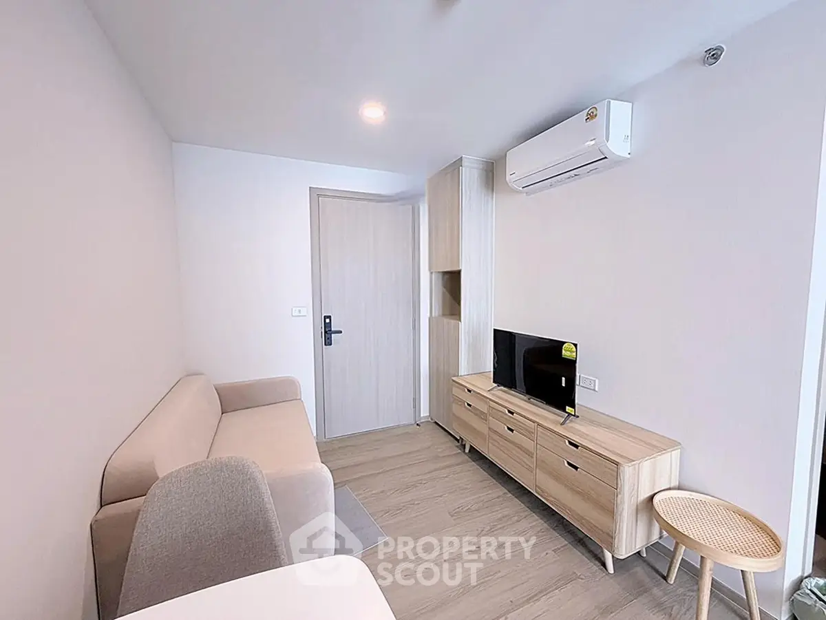 Modern living room with sleek furniture and air conditioning in a cozy apartment.