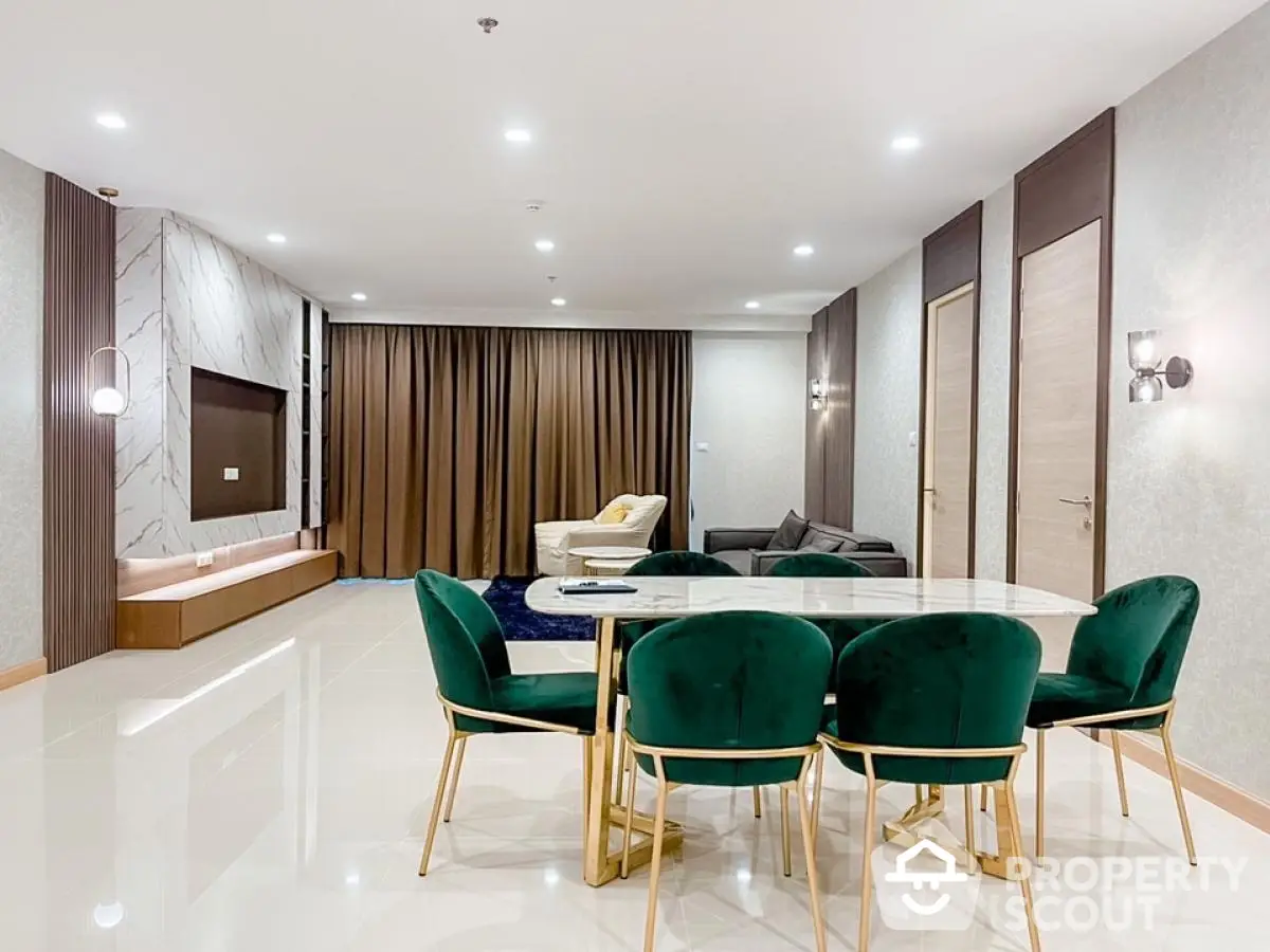 Luxurious modern living room with elegant green velvet chairs and marble TV wall