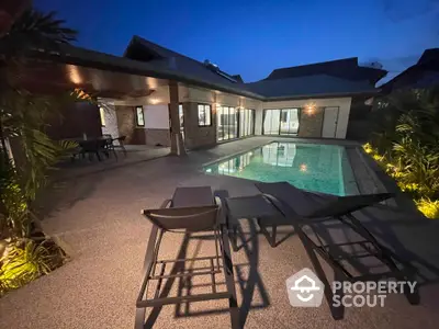 Luxurious villa with private pool and spacious patio at dusk, perfect for relaxation.