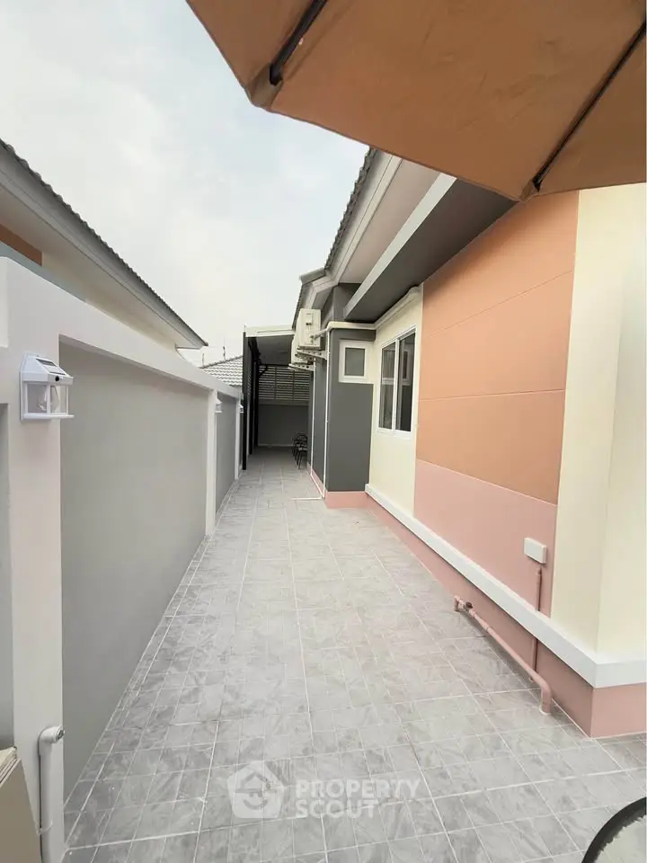 Modern exterior walkway of a stylish home with sleek design and neutral colors.