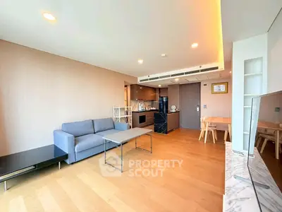 Spacious modern living room with open kitchen and elegant wooden flooring