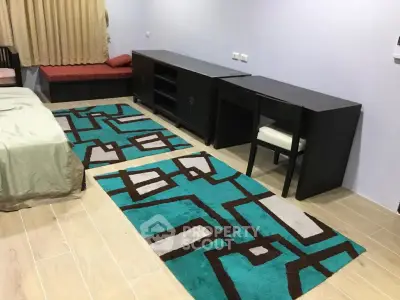 Spacious bedroom with modern furniture and stylish geometric rug