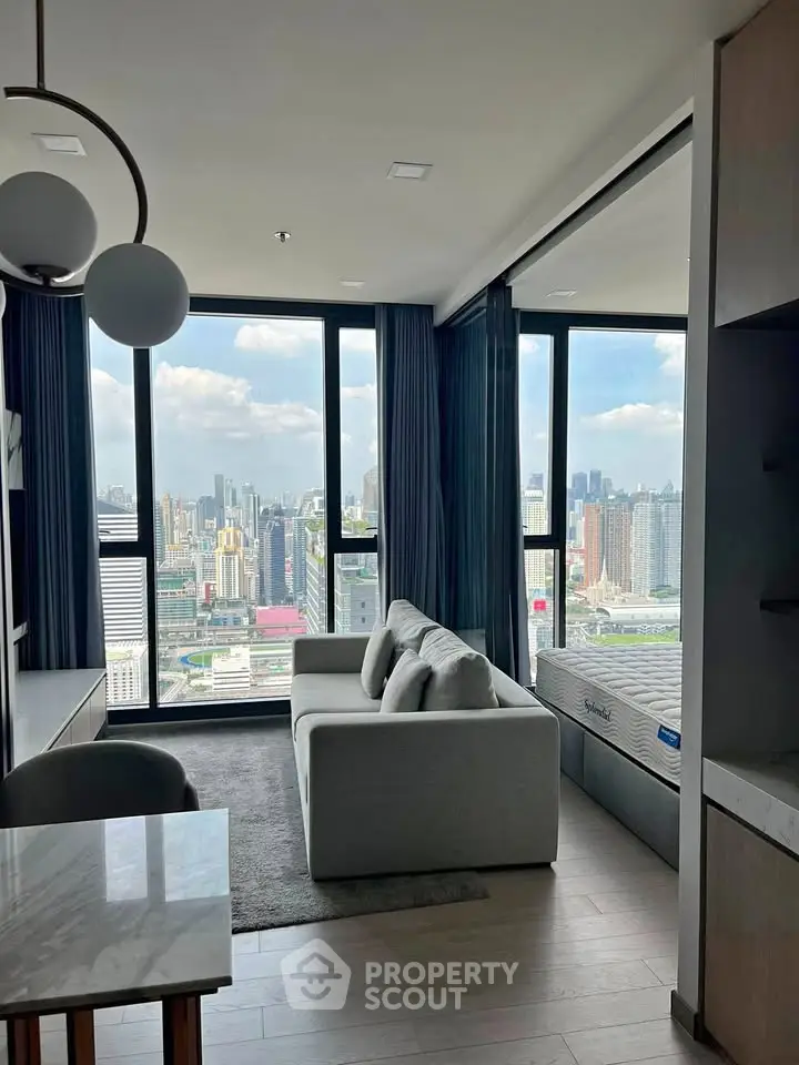Modern living room with stunning city view, featuring sleek furniture and floor-to-ceiling windows.
