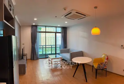 Modern living room with city view, stylish furniture, and large windows.