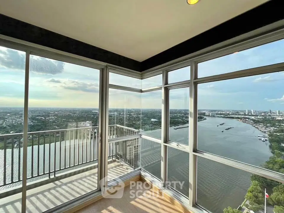 Stunning corner unit with panoramic river and city views from high-rise balcony.