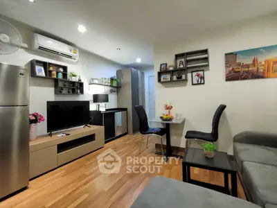 Modern living room with stylish decor and open layout, featuring a cozy seating area and entertainment center.