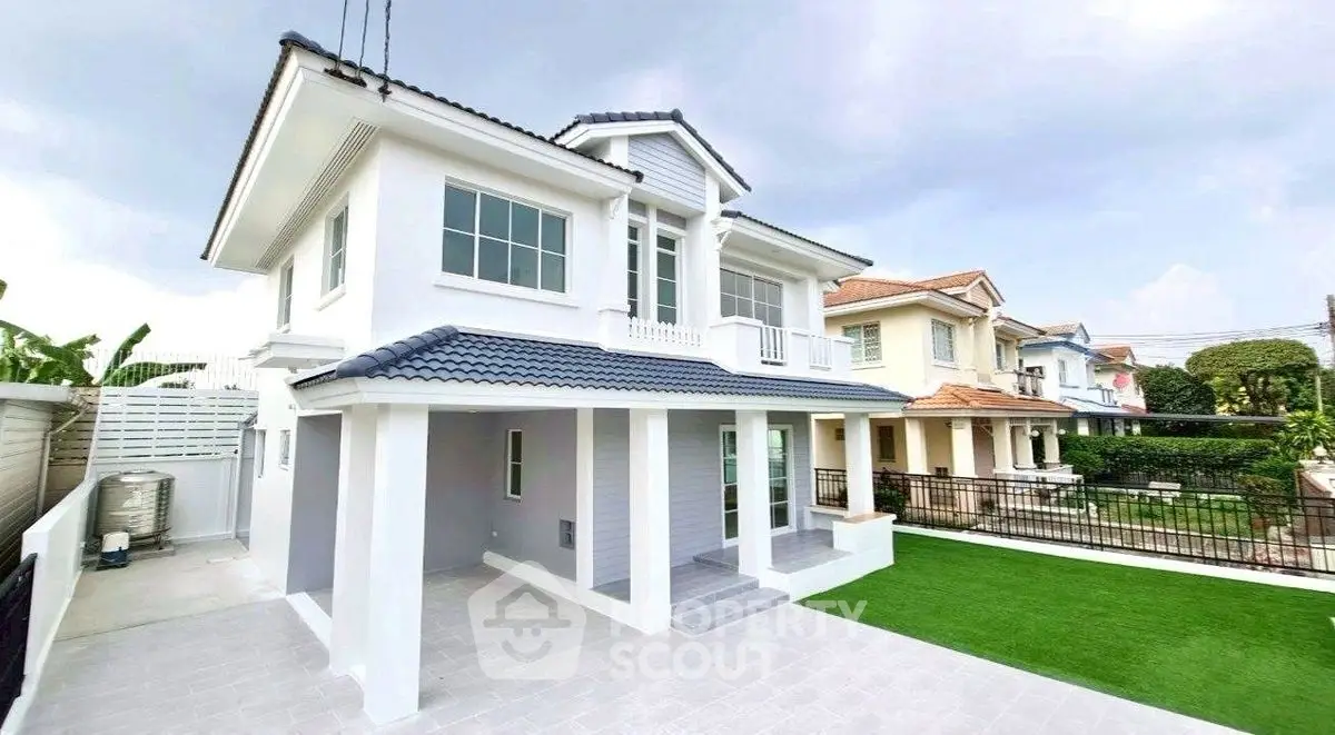 Stunning modern two-story house with spacious lawn and elegant exterior design.