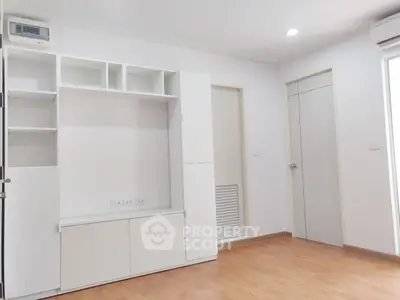 Modern minimalist living room with built-in storage and wooden flooring