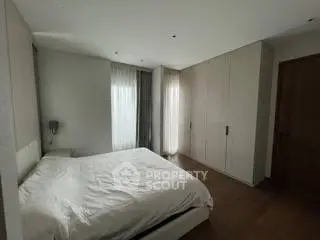 Spacious modern bedroom with sleek design and ample natural light.