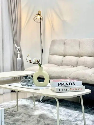 Stylish living room with modern decor, plush sofa, and elegant coffee table setup.