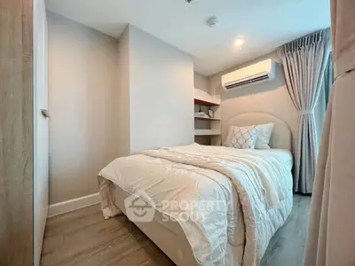Cozy bedroom with modern decor and air conditioning in a stylish apartment.