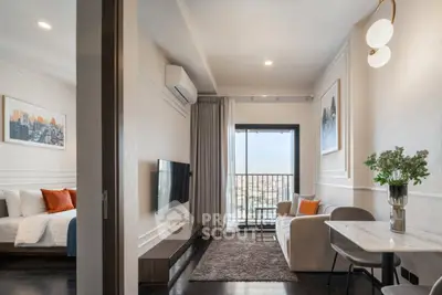 Modern apartment with cozy living room and bedroom, featuring stylish decor and city view.