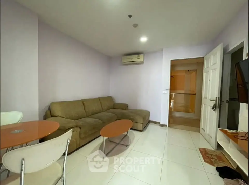 Cozy living room with modern furniture and air conditioning in a stylish apartment.