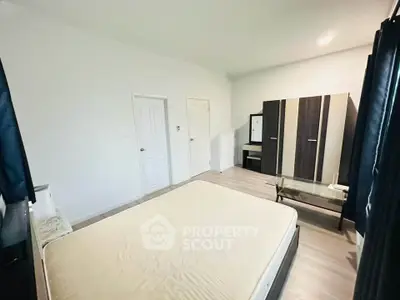 Spacious bedroom with modern wardrobe and natural light