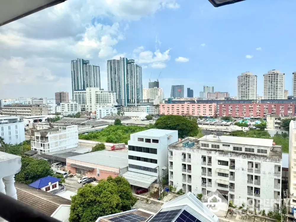 Stunning urban cityscape view from high-rise balcony with modern skyscrapers and residential buildings.