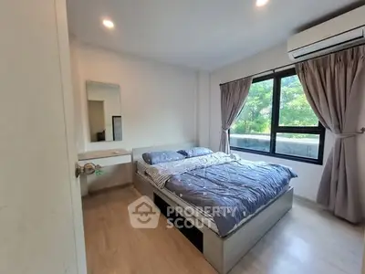 Cozy bedroom with large window and modern decor