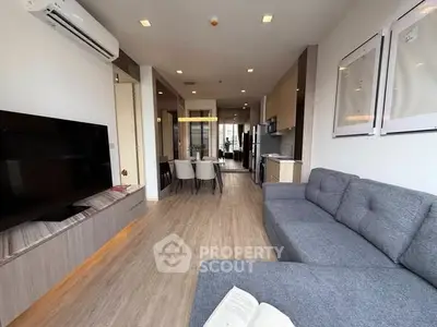 Spacious modern living room with sleek furniture and open layout, perfect for contemporary living.