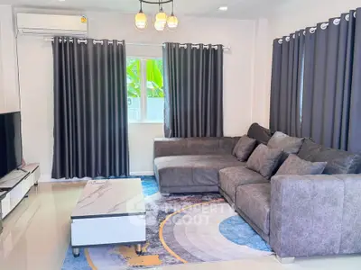 Modern living room with stylish gray sofa, elegant curtains, and chic lighting, perfect for relaxation and entertainment.