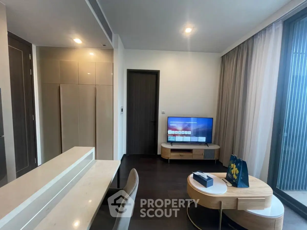 Modern living room with sleek furniture and large window for natural light.