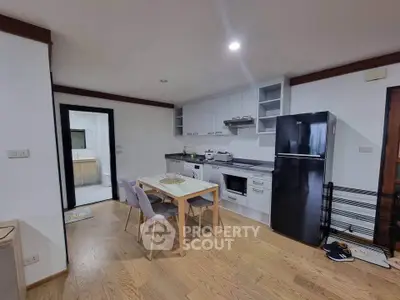 Modern kitchen with dining area and sleek appliances in open layout