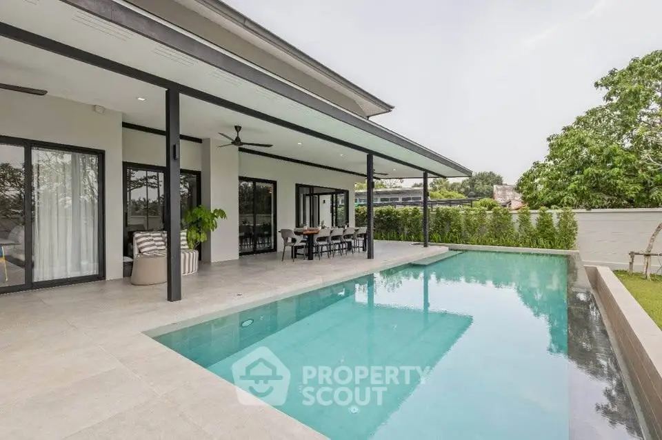 Luxurious modern home with stunning pool and spacious patio, perfect for outdoor entertaining.
