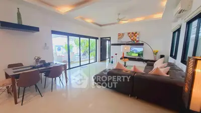 Spacious modern living room with large windows and elegant decor