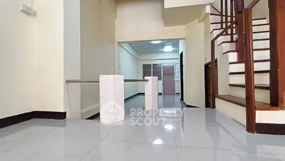 Spacious interior with modern staircase and glossy tiled flooring