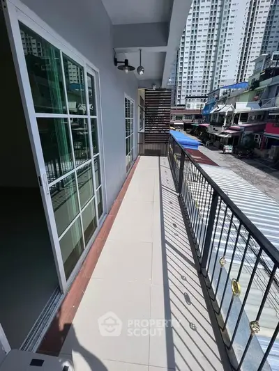 Spacious balcony with city view in modern apartment building