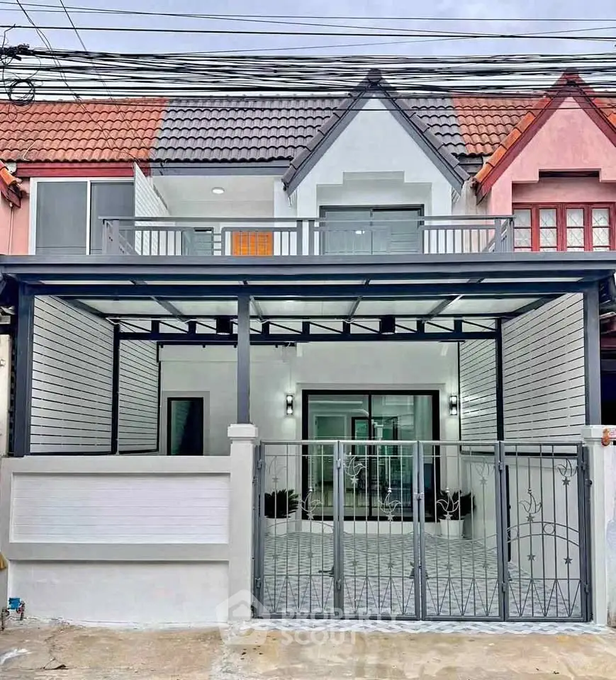 Charming townhouse with modern facade and gated entrance in a vibrant neighborhood.