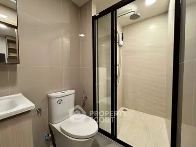 Modern bathroom with sleek shower and elegant fixtures in a contemporary apartment.
