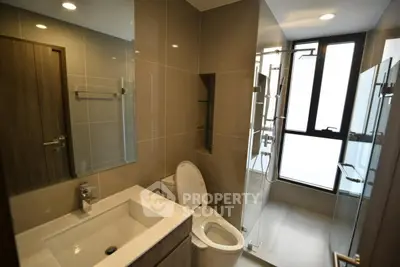 Modern bathroom with sleek fixtures and glass shower enclosure