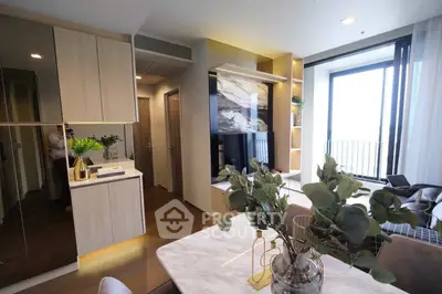 Modern living room with elegant decor and large windows offering natural light and a balcony view.