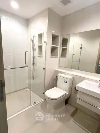 Modern bathroom with glass shower and sleek fixtures