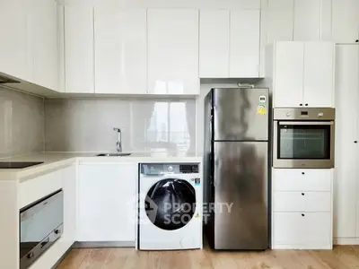 Modern kitchen with sleek appliances and ample storage space