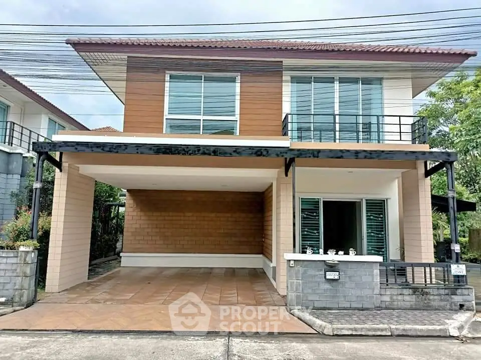 Modern two-story house with spacious driveway and balcony in suburban neighborhood.
