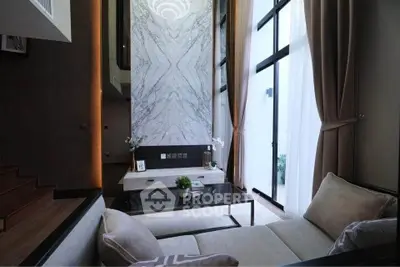 Luxurious modern living room with high ceilings and elegant marble wall feature.