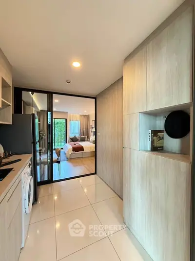 Modern apartment interior with sleek kitchen and cozy bedroom view